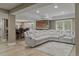 Open finished basement area featuring a gray sectional sofa, stone accent wall, and bar with seating at 24682 E Ontario Dr, Aurora, CO 80016