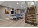 Basement game room featuring a ping pong table, dart board, and stair access at 24682 E Ontario Dr, Aurora, CO 80016