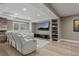 Finished basement media room with stone fireplace and comfortable white leather reclining seating at 24682 E Ontario Dr, Aurora, CO 80016