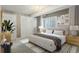 Bedroom featuring a large bed, neutral decor, a chandelier, and a window with natural light at 24682 E Ontario Dr, Aurora, CO 80016