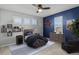 Bedroom featuring blue accent wall, unique star decor, shuttered windows and a decorative ceiling fan at 24682 E Ontario Dr, Aurora, CO 80016