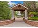 Charming entrance featuring stone pillars, a wooden pergola, and a landscaped walkway at 24682 E Ontario Dr, Aurora, CO 80016