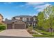 Attractive two-story house showcasing a well-manicured lawn and stone accents on the facade at 24682 E Ontario Dr, Aurora, CO 80016