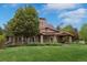 Inviting exterior featuring stone accents, a covered porch, and a well-manicured lawn at 24682 E Ontario Dr, Aurora, CO 80016