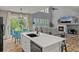 Bright kitchen with island sink, stainless steel appliances, and open views to the living room at 24682 E Ontario Dr, Aurora, CO 80016