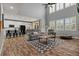 Open-concept living room with large windows, high ceilings, and hardwood floors at 24682 E Ontario Dr, Aurora, CO 80016