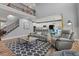 Bright living room featuring a vaulted ceiling, staircase with iron railing, and open floor plan at 24682 E Ontario Dr, Aurora, CO 80016