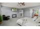 Bright primary bedroom with a ceiling fan, sitting area, and open access to the ensuite bath at 24682 E Ontario Dr, Aurora, CO 80016