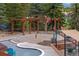 Community splash pad with colorful water features, seating, and a covered area at 24682 E Ontario Dr, Aurora, CO 80016