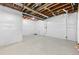 Unfinished basement with exposed ceiling, concrete flooring, and white plastic-covered walls at 16345 Milwaukee St, Thornton, CO 80602