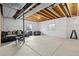 Unfinished basement with exposed ceiling, concrete flooring, and bright windows at 16345 Milwaukee St, Thornton, CO 80602