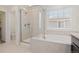 Modern bathroom featuring a glass-enclosed shower and a separate soaking tub at 16345 Milwaukee St, Thornton, CO 80602