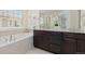 Luxurious bathroom with double sinks, granite countertops, and a soaking tub at 16345 Milwaukee St, Thornton, CO 80602