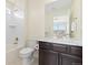 Well-lit bathroom with vanity, tile flooring, and shower and tub at 16345 Milwaukee St, Thornton, CO 80602
