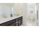 Bathroom with double sink vanity and a door leading to a separate toilet at 16345 Milwaukee St, Thornton, CO 80602