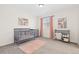 Cozy Bedroom with crib, changing table, and a plush pink rug at 16345 Milwaukee St, Thornton, CO 80602