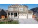 Charming two-story home showcasing a well-manicured lawn, attached three car garage, and inviting front porch at 16345 Milwaukee St, Thornton, CO 80602