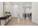 Bright foyer with beautiful wood floors, a console table with plant, and views into the home office at 16345 Milwaukee St, Thornton, CO 80602