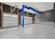 Spacious three car garage featuring epoxy flooring and painted walls at 16345 Milwaukee St, Thornton, CO 80602