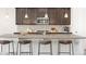 Spacious kitchen with granite counters, stainless appliances, and seating at the kitchen island at 16345 Milwaukee St, Thornton, CO 80602