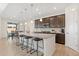 Modern kitchen features a large island with seating and stainless steel appliances at 16345 Milwaukee St, Thornton, CO 80602