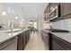 Modern kitchen featuring stainless steel appliances, granite countertops, and an eat-in dining area with natural light at 16345 Milwaukee St, Thornton, CO 80602