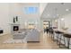 Spacious living room with stone fireplace, vaulted ceilings, modern furnishings, and wood floors at 16345 Milwaukee St, Thornton, CO 80602