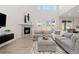 Open living area featuring a fireplace, neutral decor, vaulted ceilings, wood floors, and stylish decor at 16345 Milwaukee St, Thornton, CO 80602