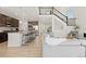 Open concept living room and kitchen featuring a large island with bar seating at 16345 Milwaukee St, Thornton, CO 80602