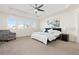 Spacious primary bedroom with trey ceilings, chair, and lots of natural light at 16345 Milwaukee St, Thornton, CO 80602