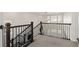 Second floor staircase landing with wood railing and spindals at 16345 Milwaukee St, Thornton, CO 80602