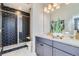 Modern bathroom with a double vanity and a hexagonal tile shower at 16551 Peak Way, Broomfield, CO 80023