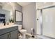 Modern bathroom with gray vanity, shower, and patterned floor at 16551 Peak Way, Broomfield, CO 80023