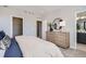 Comfortable bedroom with built-in dresser and ensuite bathroom access at 16551 Peak Way, Broomfield, CO 80023