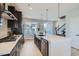 Modern kitchen with island, stainless steel appliances, and white quartz countertops at 16551 Peak Way, Broomfield, CO 80023