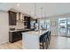 Modern kitchen with island, stainless steel appliances, and white quartz countertops at 16551 Peak Way, Broomfield, CO 80023