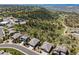 An aerial view of a neighborhood with well-spaced homes surrounded by lush greenery and scenic hills at 438 Galaxy Dr, Castle Rock, CO 80108