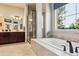 Bathroom showcasing a soaking tub, and sinks, and a walk in shower with glass door at 438 Galaxy Dr, Castle Rock, CO 80108