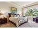 This primary bedroom features a large window, trey ceilings, and a king bed at 438 Galaxy Dr, Castle Rock, CO 80108