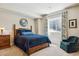 Calming bedroom features a wood bed, accent chair, and natural light from the window at 438 Galaxy Dr, Castle Rock, CO 80108