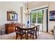 Traditional dining room showcasing a round table, buffet, pendant lighting, and large window for a naturally lit space at 438 Galaxy Dr, Castle Rock, CO 80108