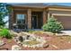 Inviting home exterior with a charming stone porch and beautifully landscaped yard with a tranquil water feature at 438 Galaxy Dr, Castle Rock, CO 80108