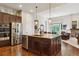 Modern kitchen with stainless steel appliances, granite counters, a large kitchen island, and sleek dark wood cabinets at 438 Galaxy Dr, Castle Rock, CO 80108