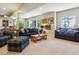 Spacious living room with plush sofas, a wooden coffee table, and several large windows at 438 Galaxy Dr, Castle Rock, CO 80108