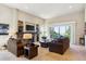 Open-concept living room featuring a stone fireplace, built-in shelving, and sliding doors leading to an outdoor balcony at 438 Galaxy Dr, Castle Rock, CO 80108