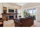 Inviting living room showcasing a stone fireplace, custom built-ins, and a sliding glass door to the outdoor patio at 438 Galaxy Dr, Castle Rock, CO 80108
