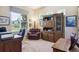 Well-lit office with large window, comfortable leather seating, and custom built-in shelving at 438 Galaxy Dr, Castle Rock, CO 80108