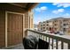 Exterior balcony view with a grill, seating, and a view of the parking lot and nearby apartment buildings at 7440 S Blackhawk St # 16-208, Englewood, CO 80112