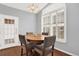 Cozy dining area featuring wood floors, a round table, and a large window at 7440 S Blackhawk St # 16-208, Englewood, CO 80112
