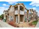 Inviting condo with stone accents, private balcony, and well-maintained landscaping at 7440 S Blackhawk St # 16-208, Englewood, CO 80112